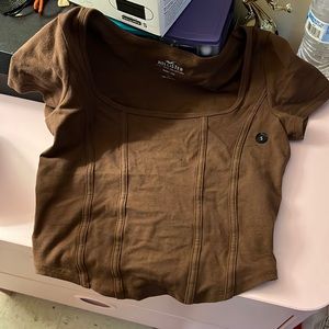 This is a size small shirt, brown, and only tried on once.